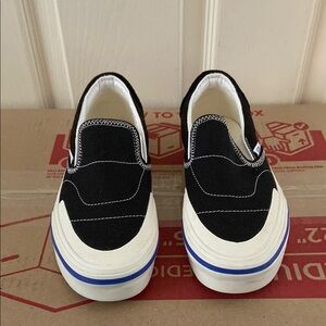 Vans Black and White Slip-Ons with Blue Detail